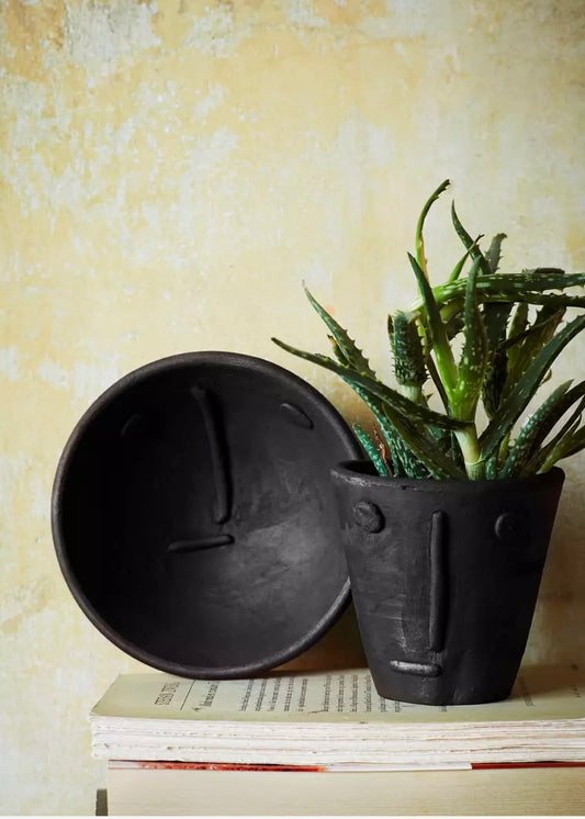 Handmade clay flower pot with face imprint